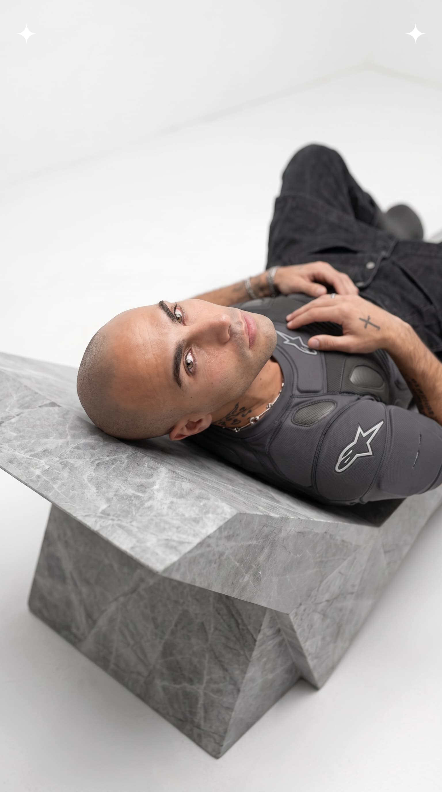 Figure lying across a carved stone form