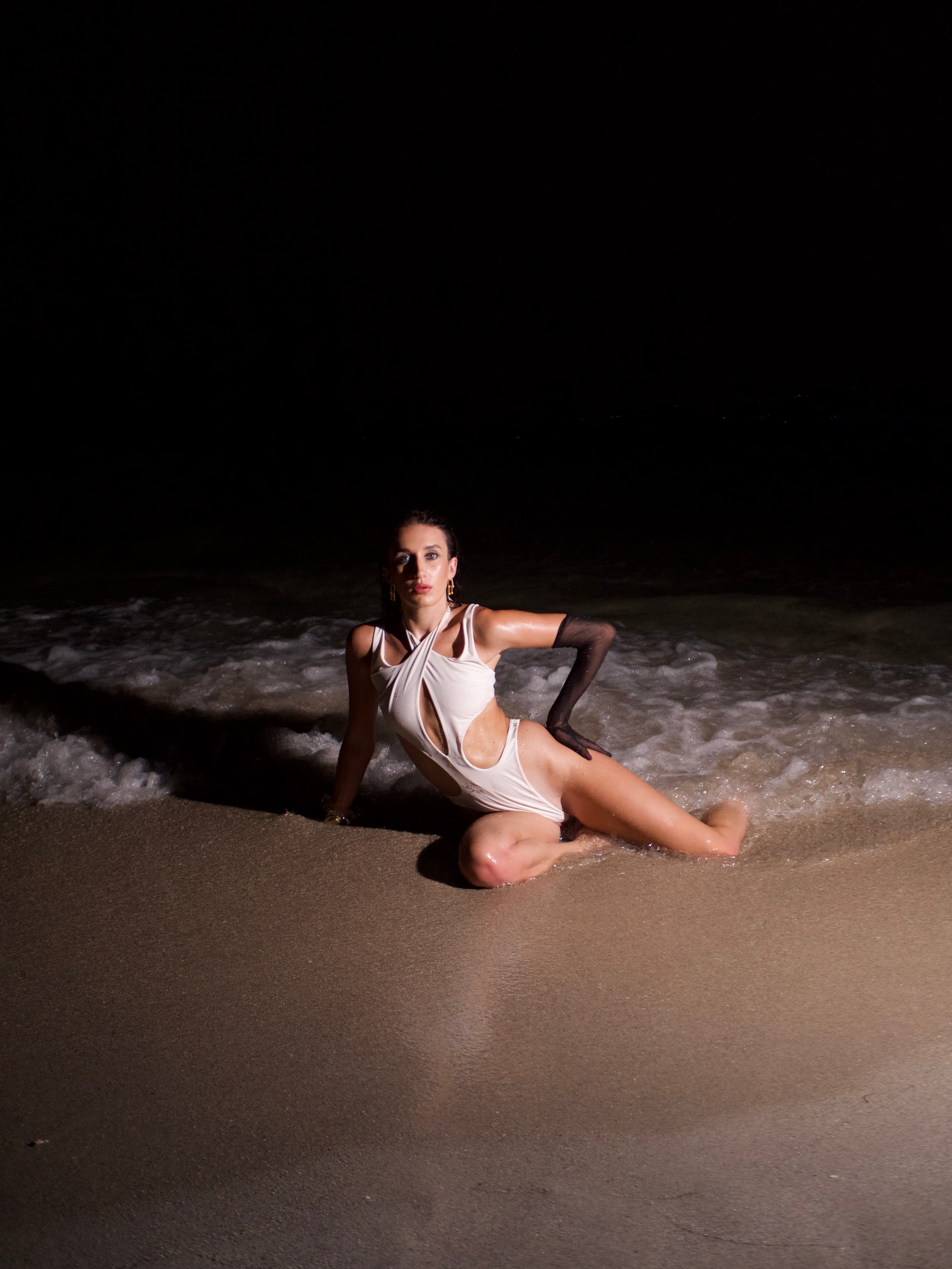 White swimsuit in surf at night